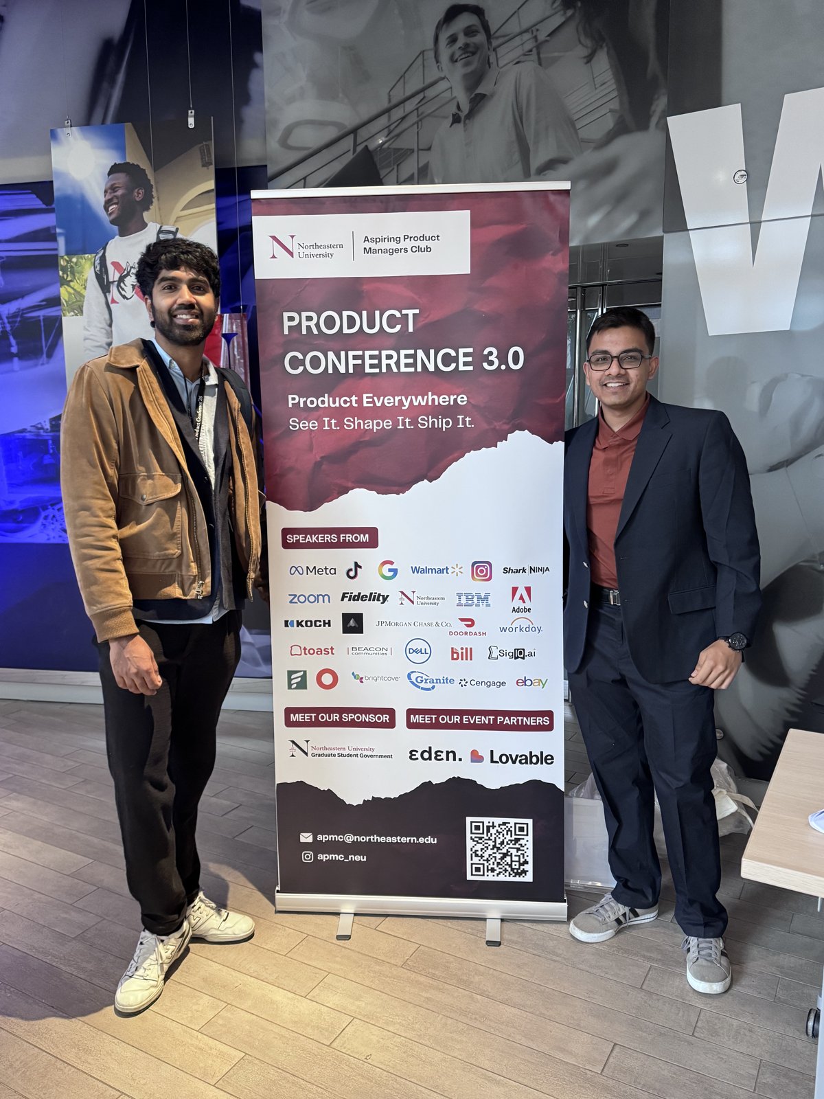 Rajaseelan at the APMC Product Conference 3.0 banner at Northeastern University